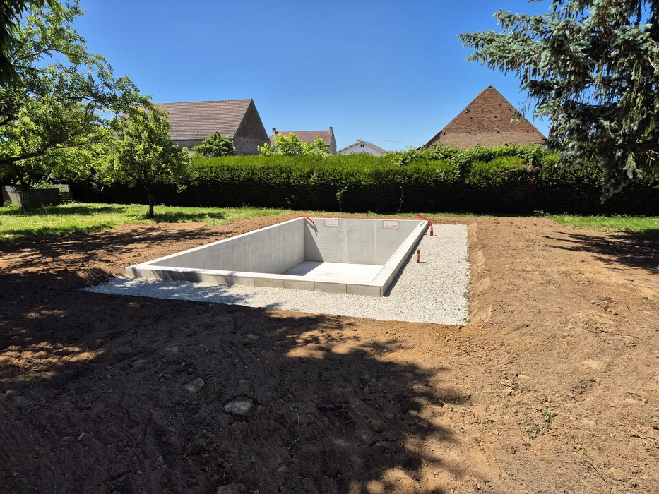 Chantier de construction piscine en cours dans jardin résidentiel