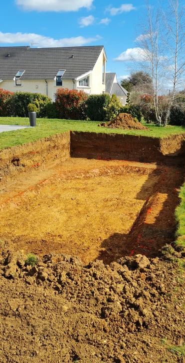 Chantier de construction extérieur avec ouvrier utilisant un compacteur pneumatique sur sol sablonneux